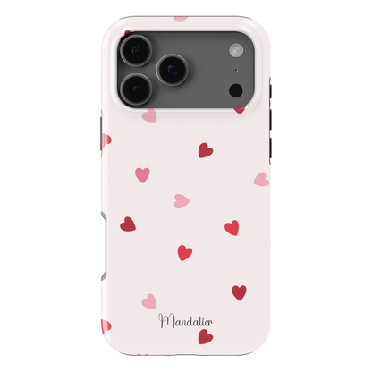 Sprinkled Hearts phone case with scattered heart print design, glossy finish, dual-layer shock-absorbing protection, available in MagSafe and tough protective options