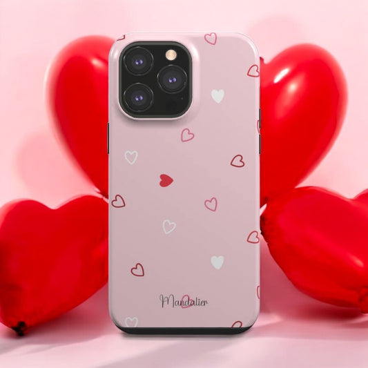 Love Whispers Tough Phone Case placed on a cozy setup with candles and flowers, highlighting its elegance and durability.