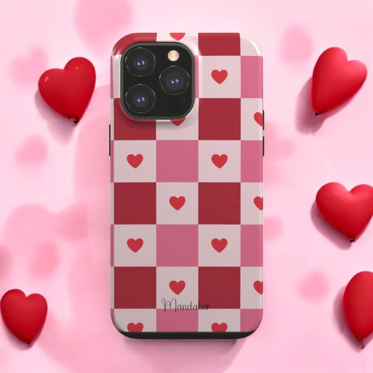 Sweetheart Plaid Tough Phone Case on a rustic table with accessories, highlighting its stylish plaid design.
